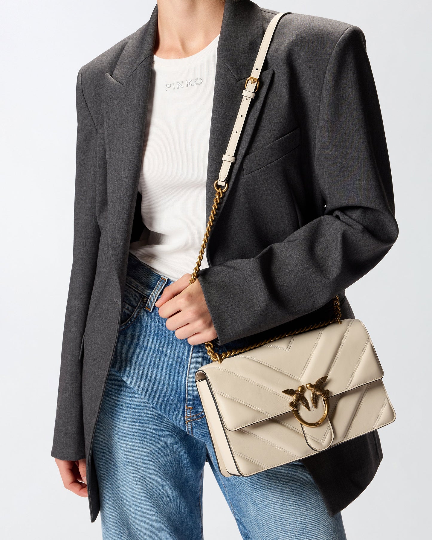 Medium Love Bag pebbled leather crossbody bag with V-shaped pattern and logo