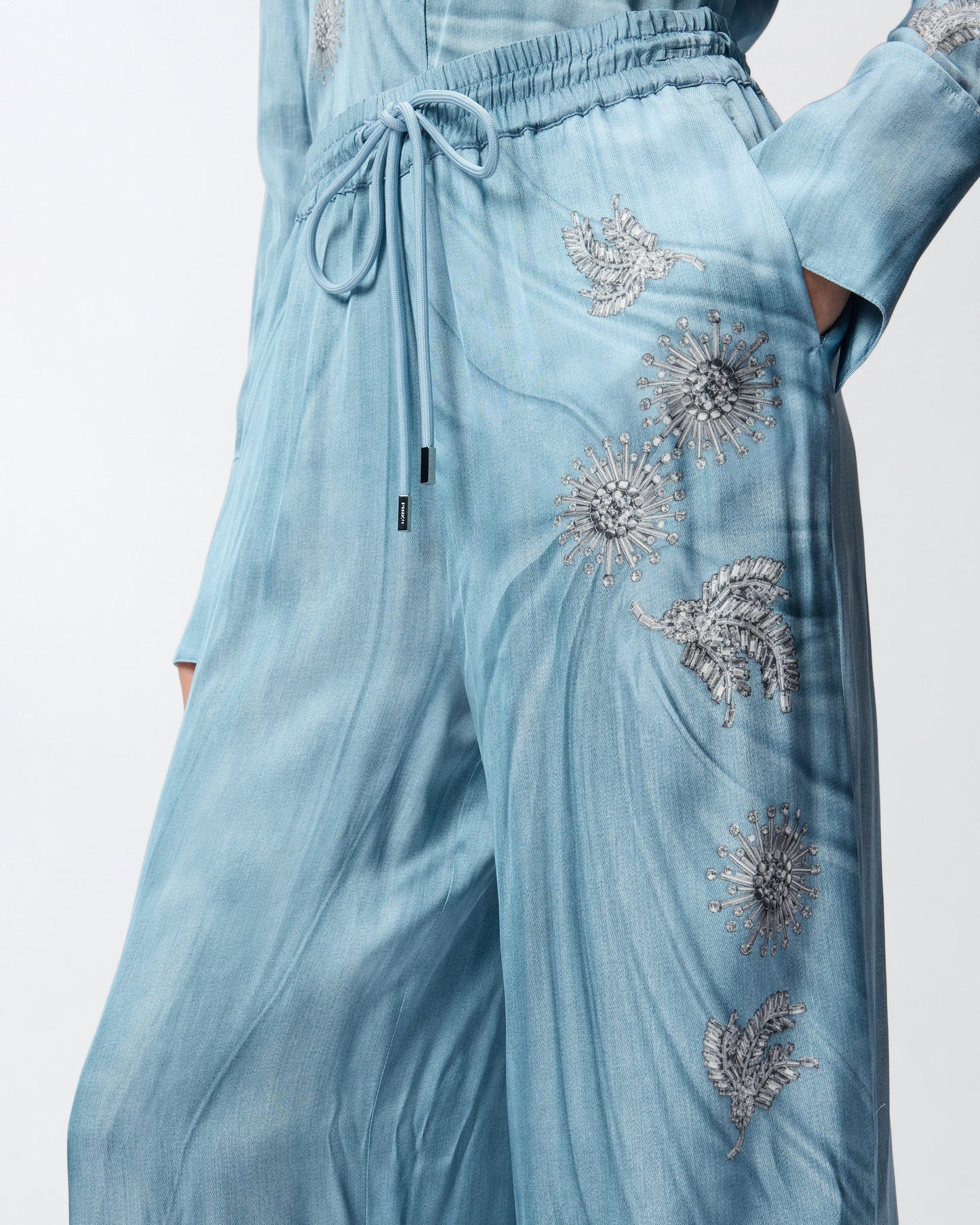 Fluid trousers with placed jewel print