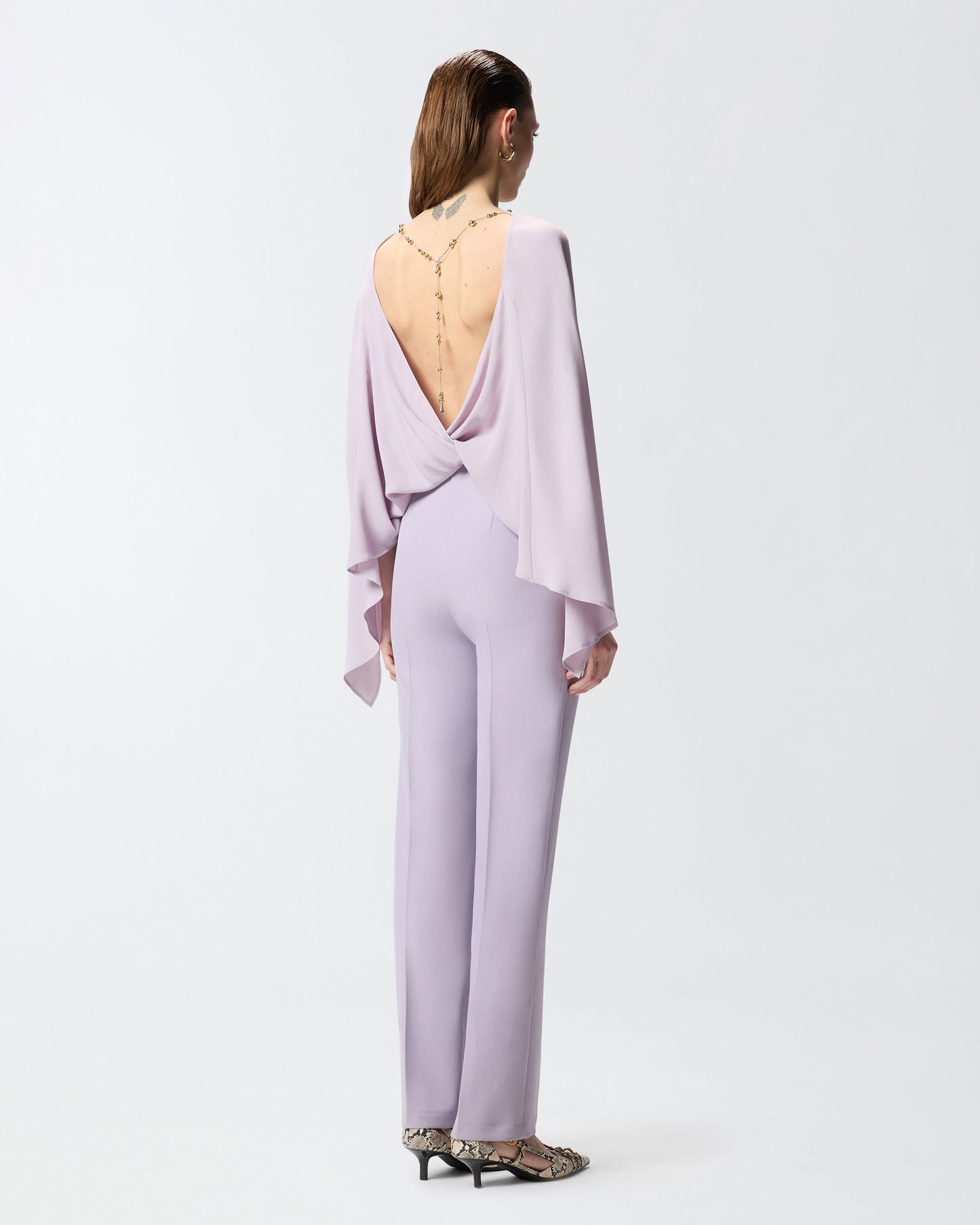 Long playsuit with exposed back and jewel necklace