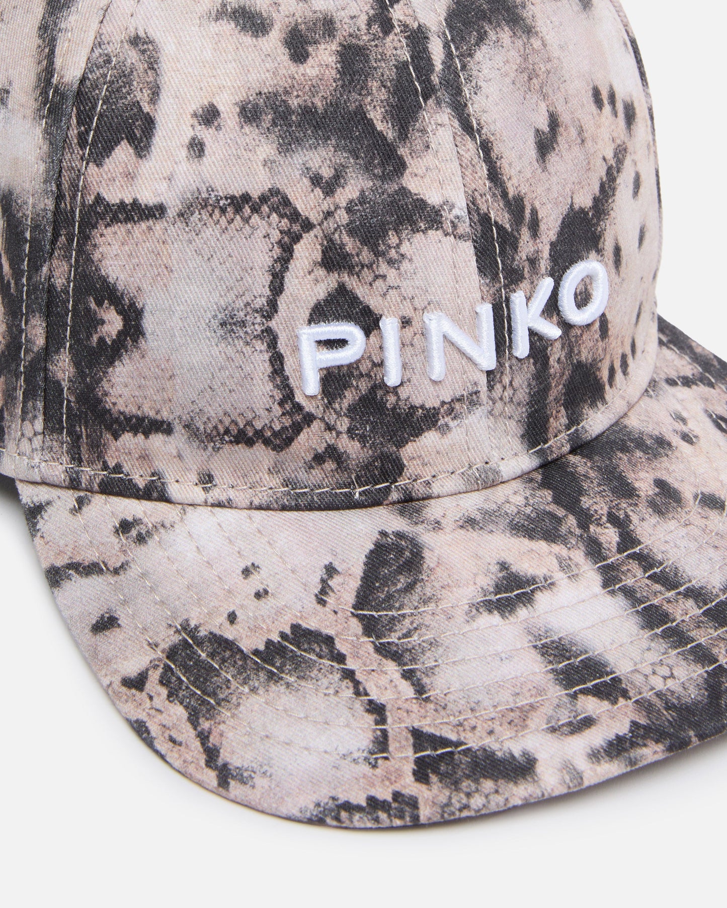 Cap with peak and snake print